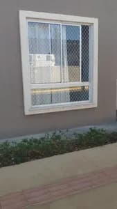 Rede de proteção branca instalada em janela térrea com jardim frontal no bairro Piratininga em Campo Grande MS - UauTelas Bairro Piratininga MS